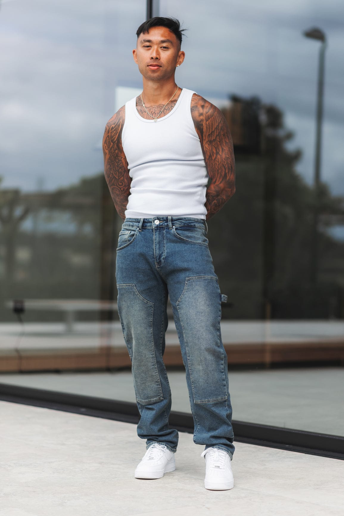 Close detail of the stone-washed denim, belt loops and zip fly